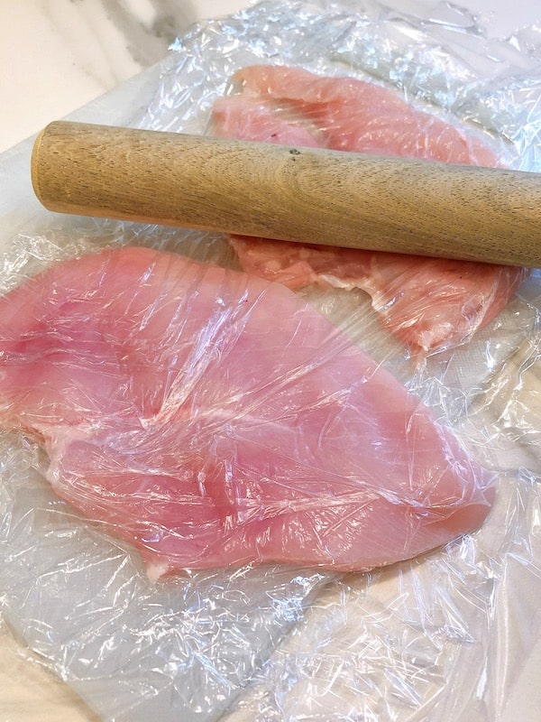 chicken breasts with rolling pin.