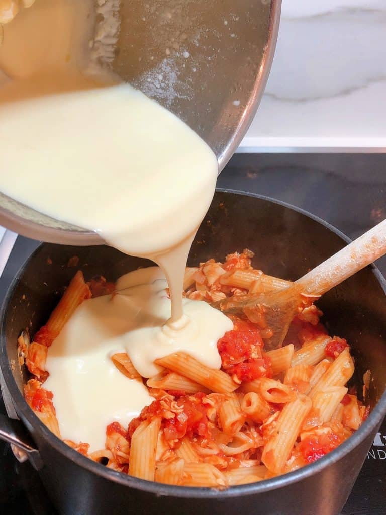 Adding cheese sauce to pasta bake