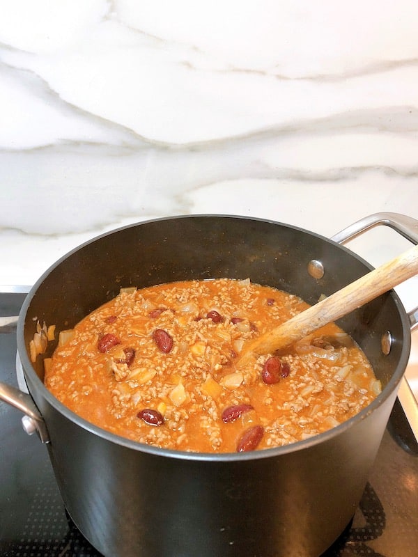stirring homemade chili 