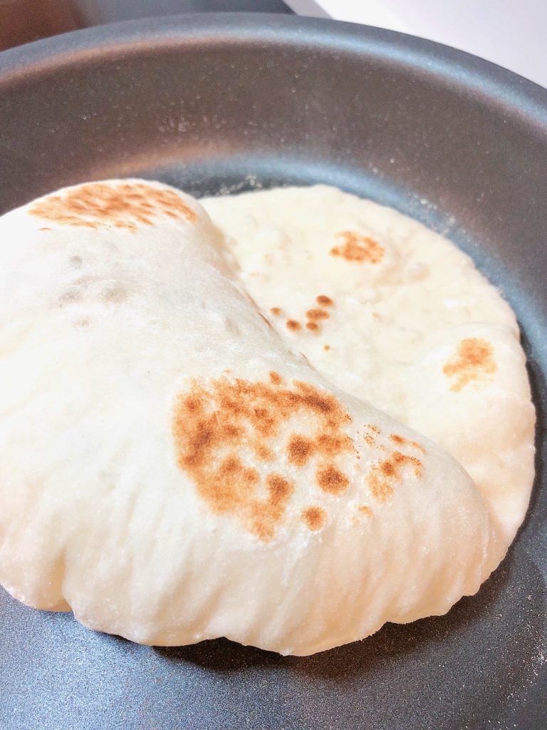 Pita bread dough in non-stick frying pan.