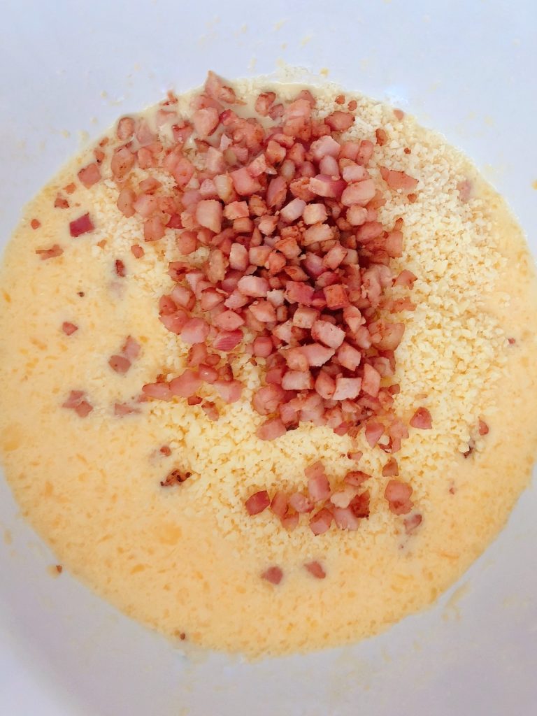 mixing grated cheese and bacon bits