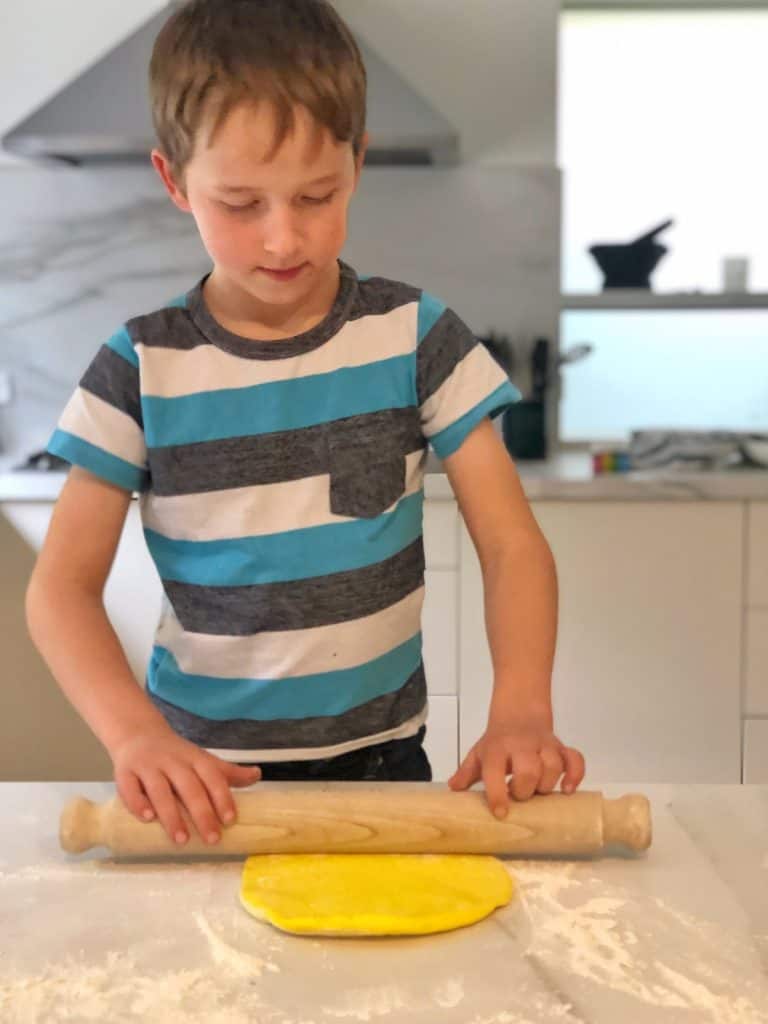 Rolling out rainbow bread dough