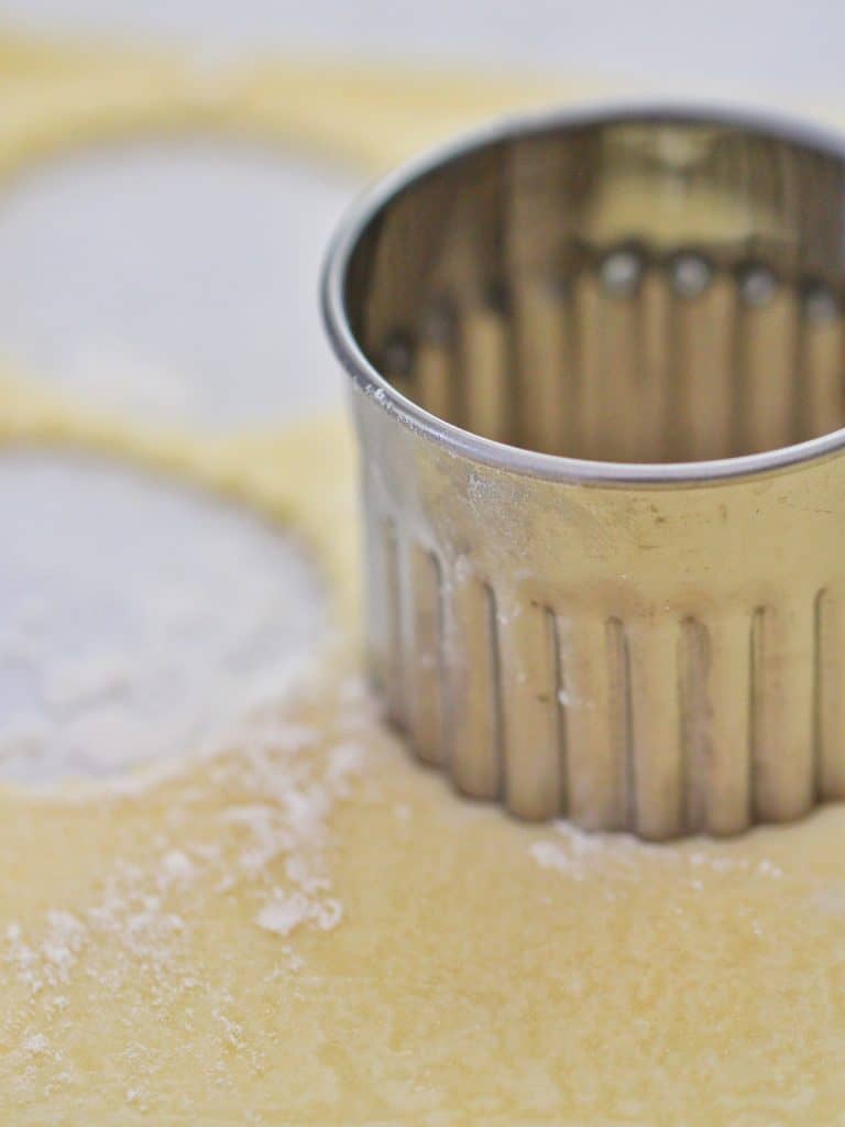 Cutting pastry with cookie cutter