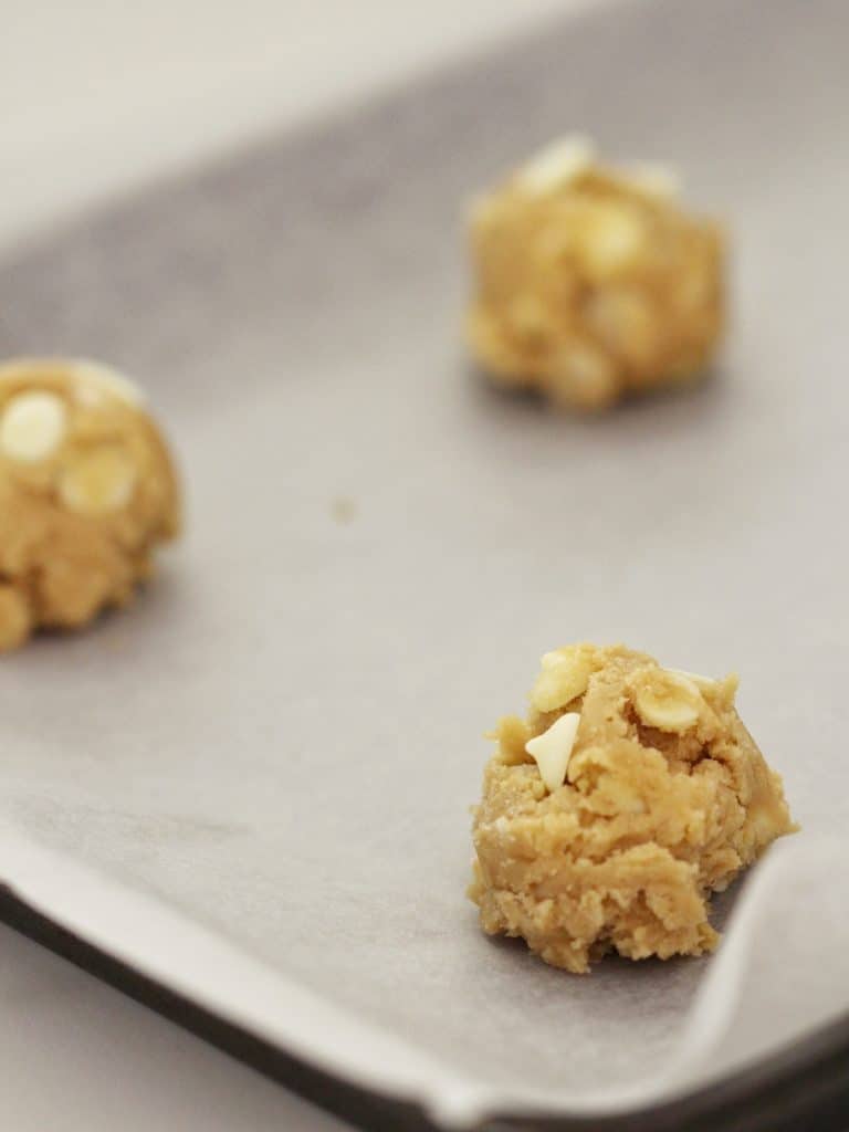 a scoop of Macadamia Nut Cookies on baking paper 