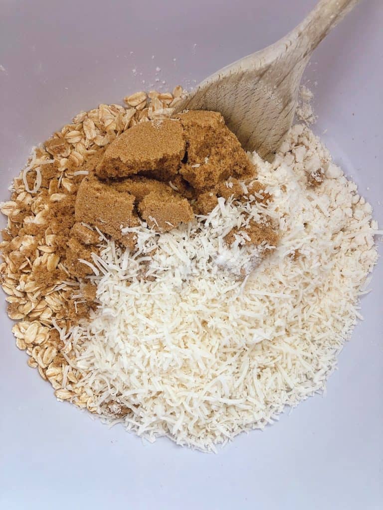 mixing the dry ingredients of date and oat slice