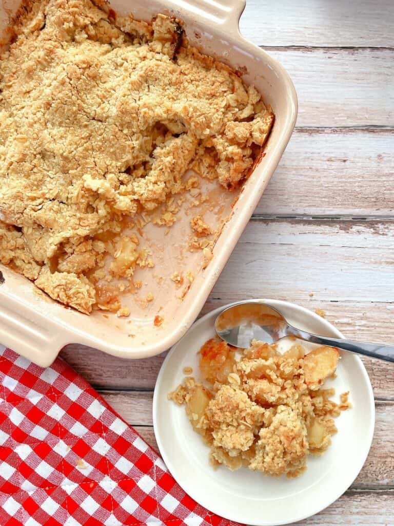 Thermomix apple crumble in dish with a serving dish