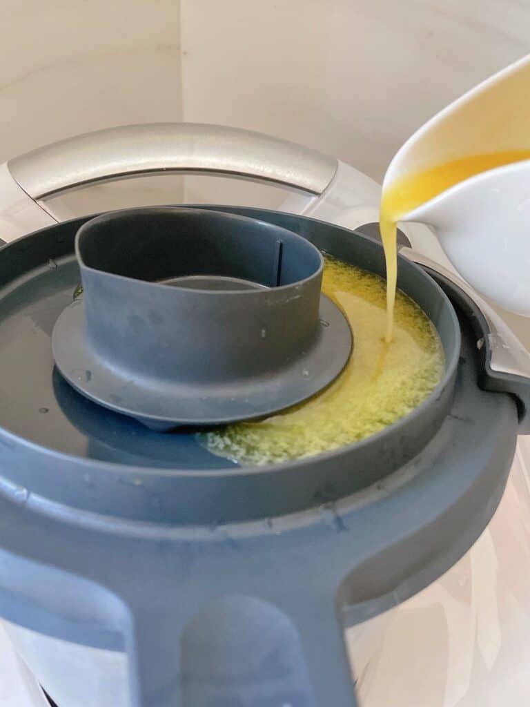 Pouring melted butter onto thermomix for Hollandaise sauce