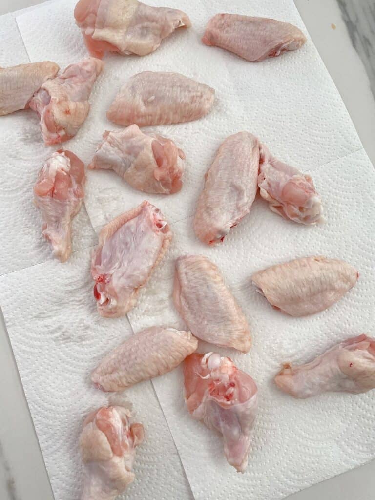 raw chicken wings on a paper towel
