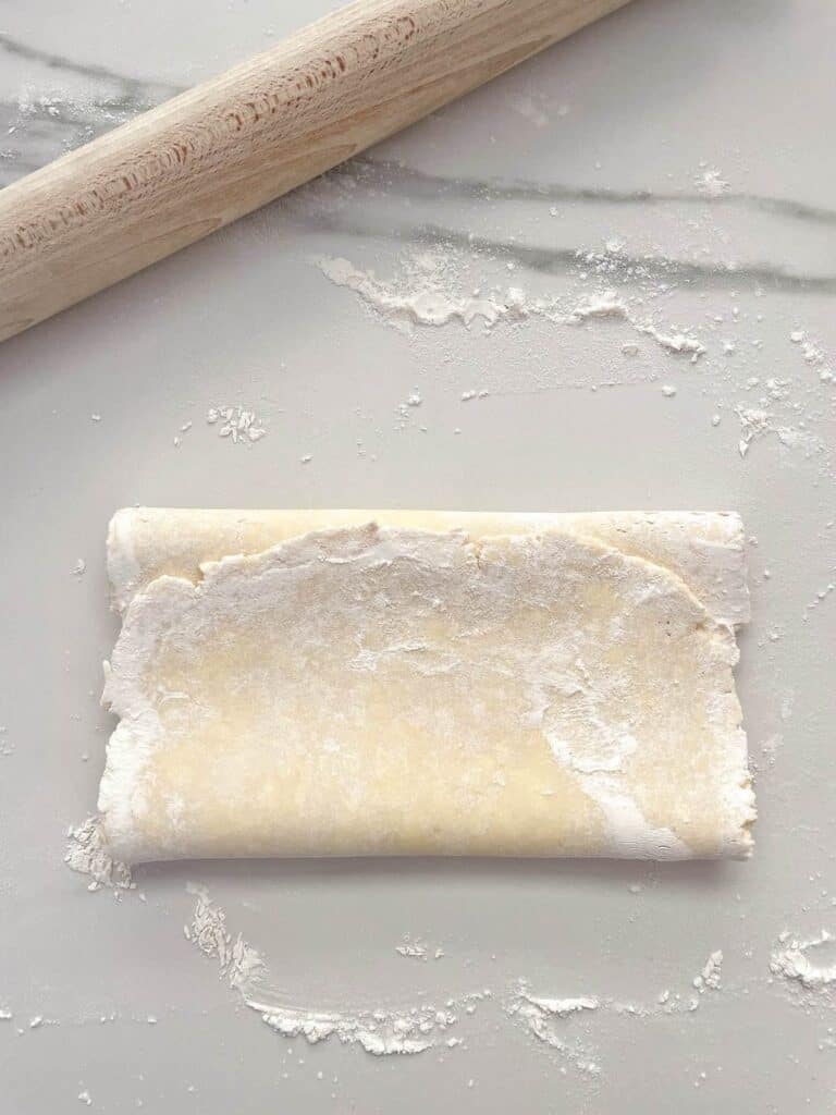 Sausage Rolls fold dough with rolling pin