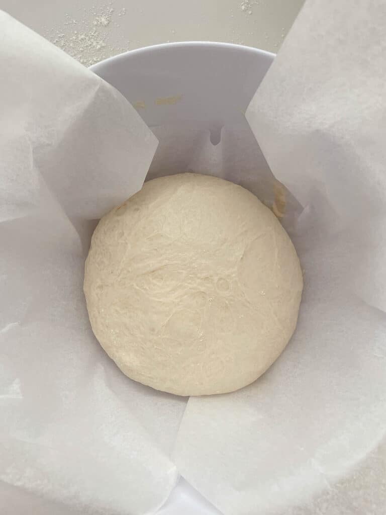 bread dough on a bowl with baking paper