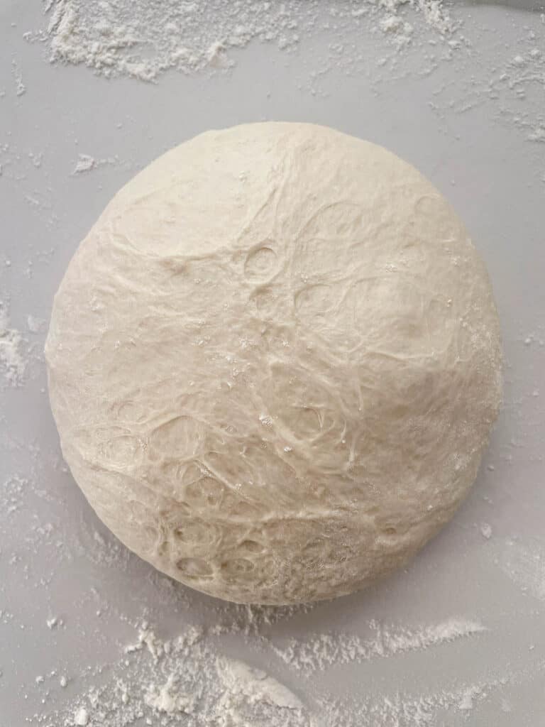 A dough on a table with flour