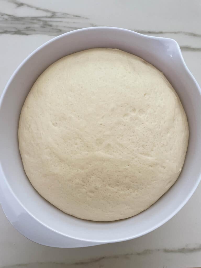 doubled size dough in a bowl