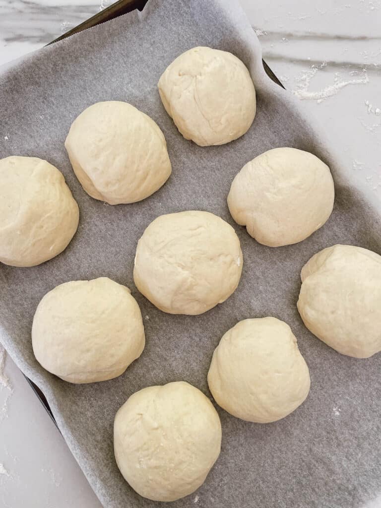 arrange bread rolls into baking tray.