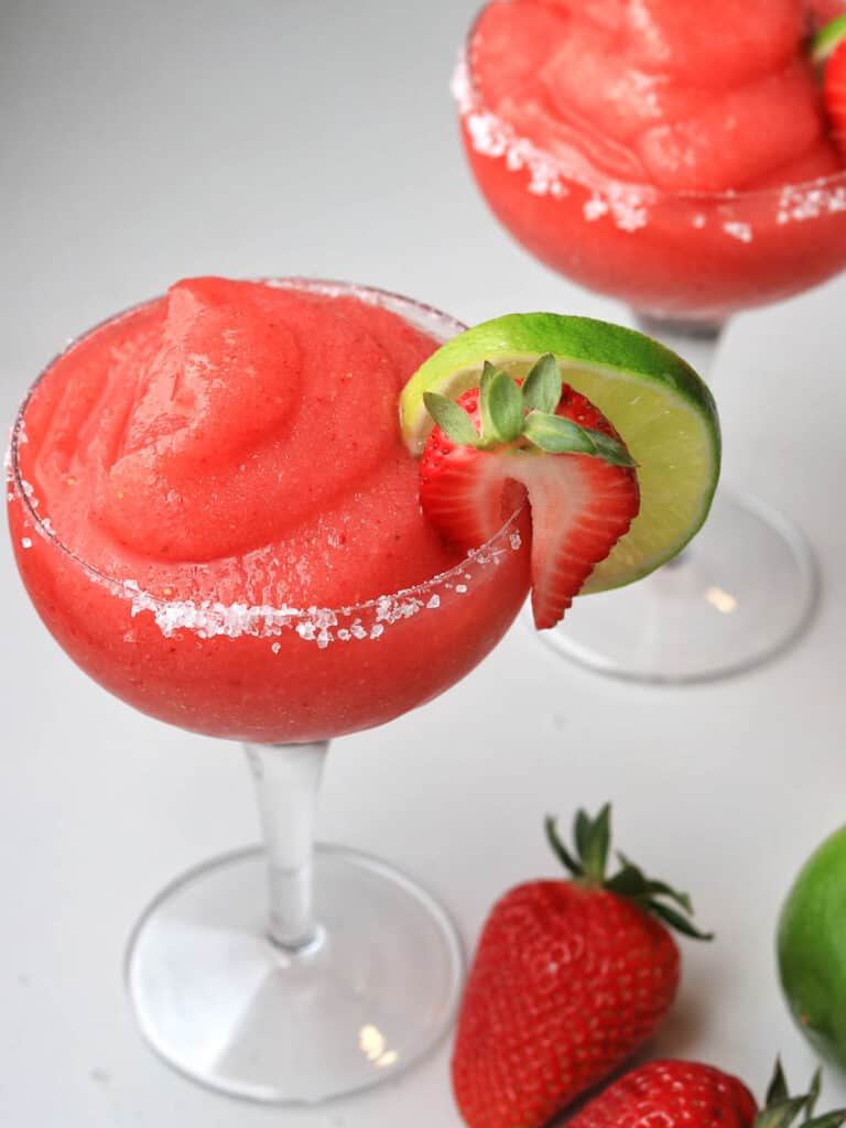 a glass of Strawberry Margaritas with strawberry and lime.