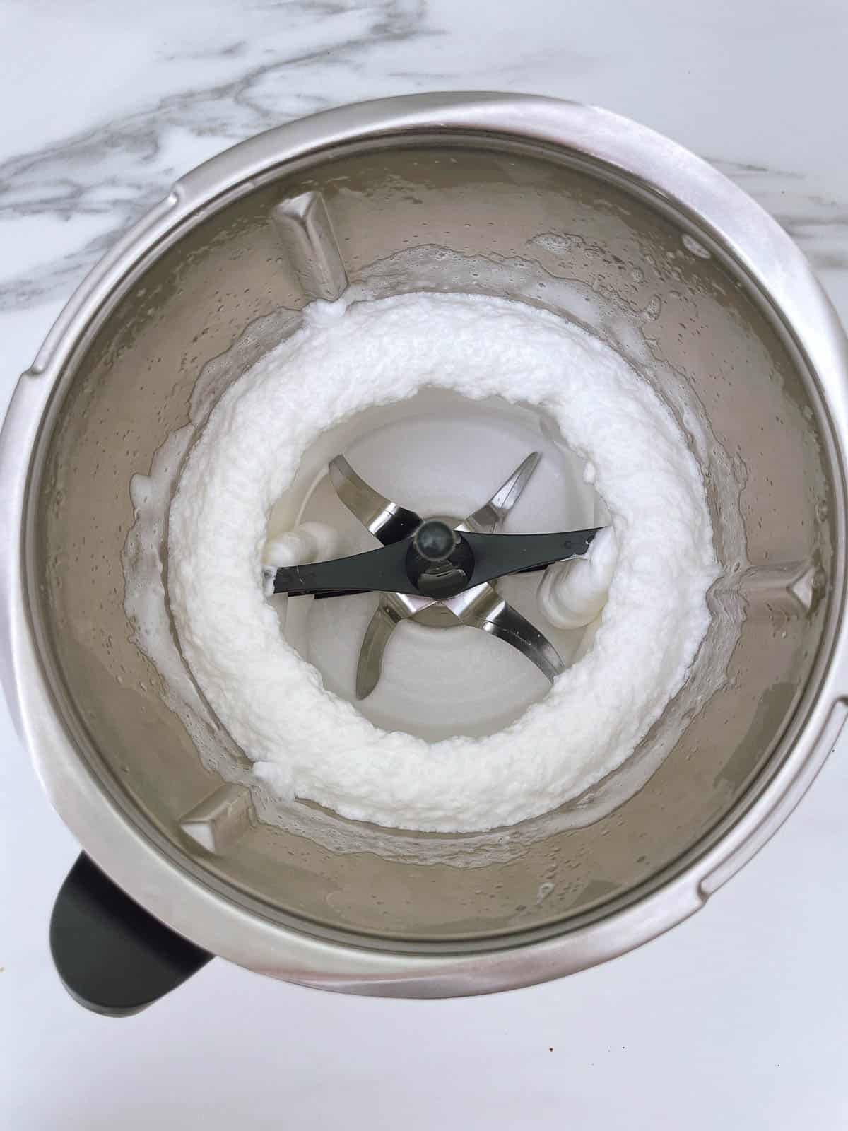 Thermomix bowl with whisked egg whites inside.