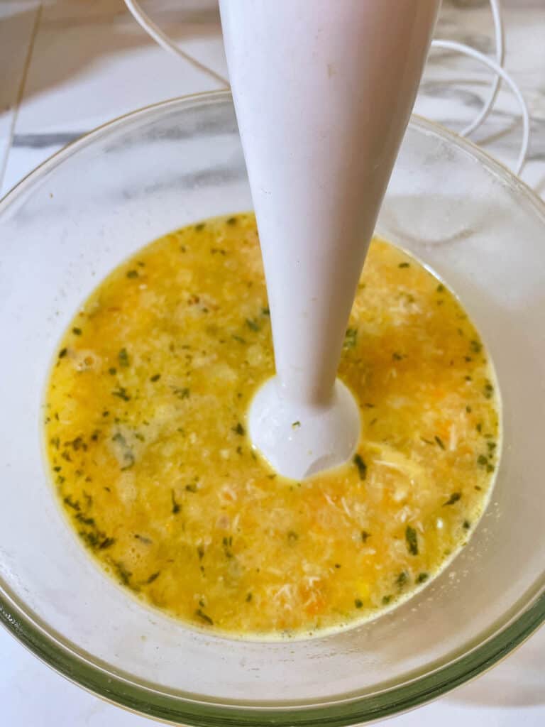 a bowl of chicken soup with blender