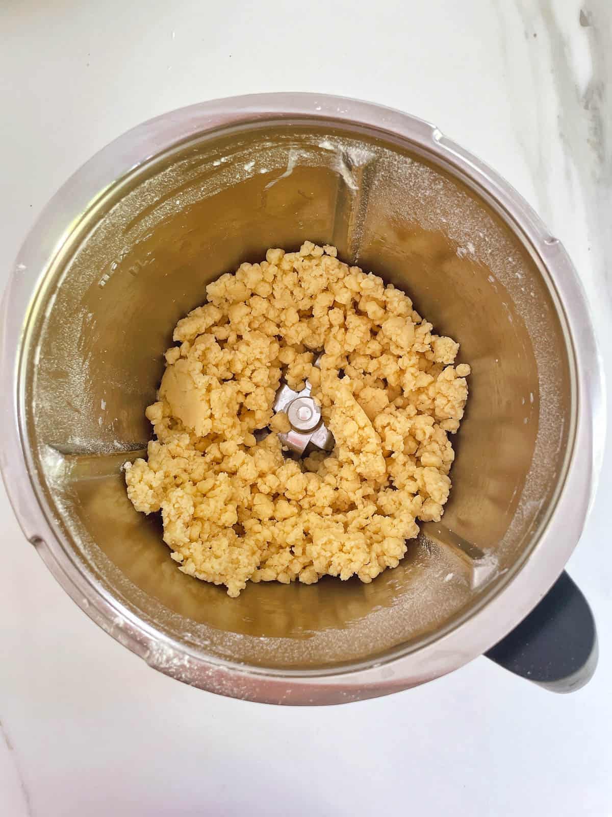 Shortbread crumbs in Thermomix bowl.