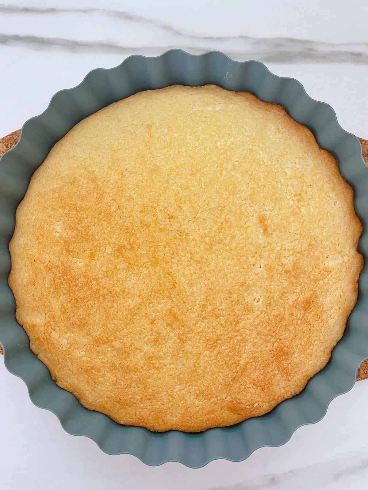Baked sugar cookie base in tart tin.
