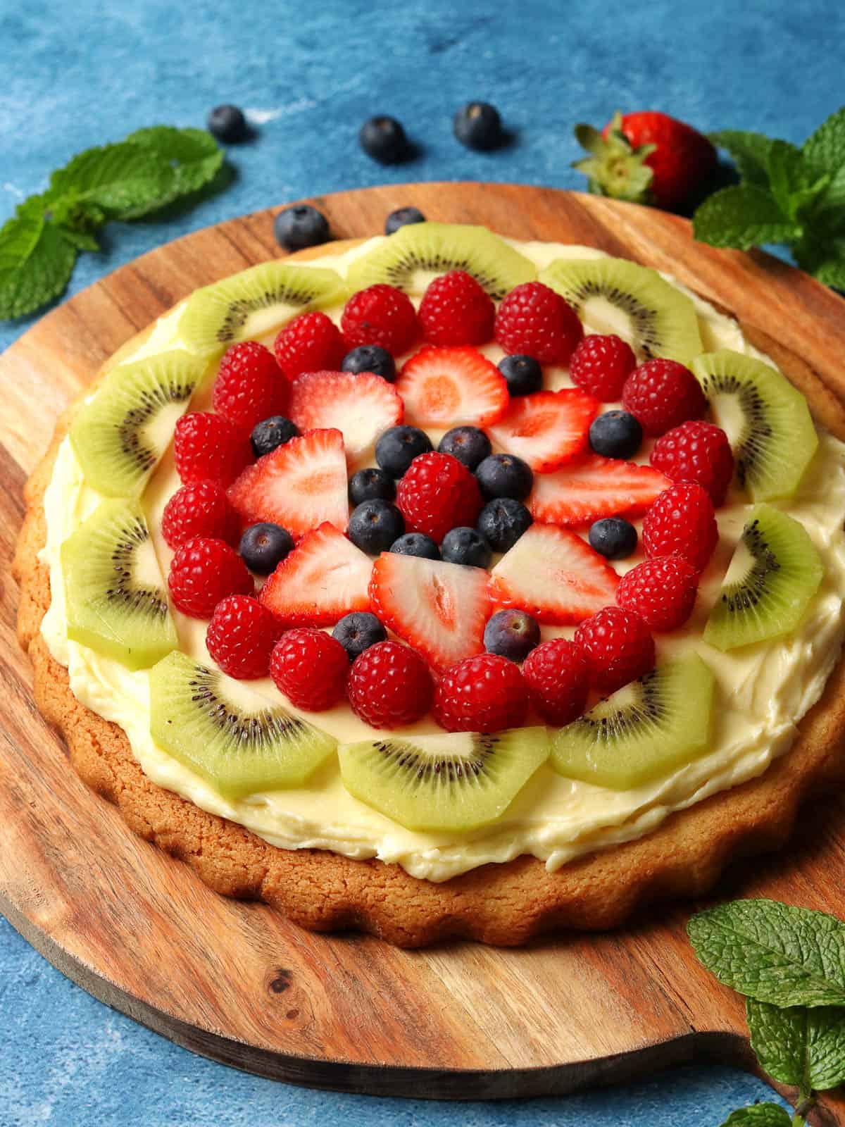 Thermomix fruit pizza decorated with colourful fruit.