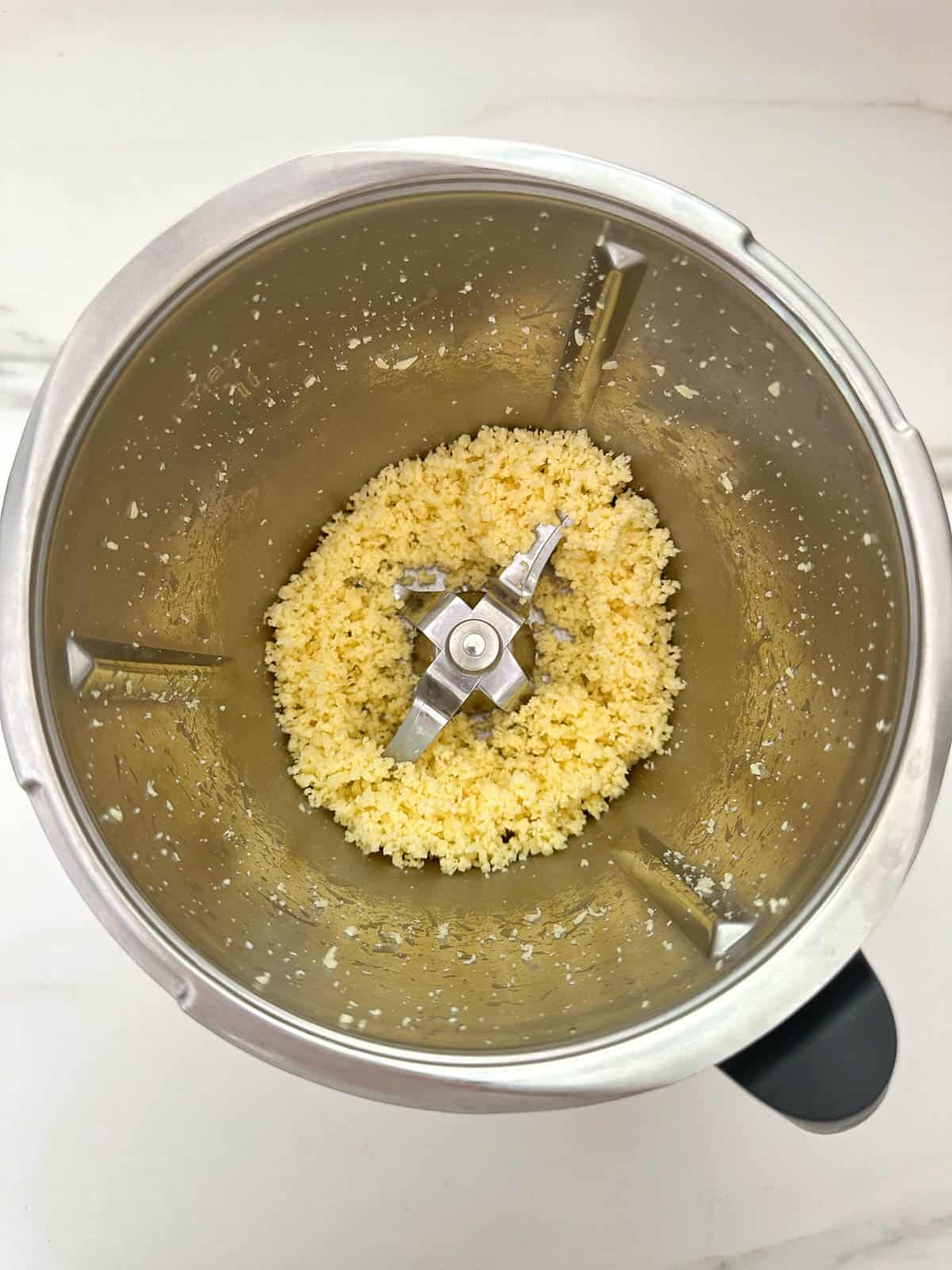 Grated cheese in Thermomix bowl.