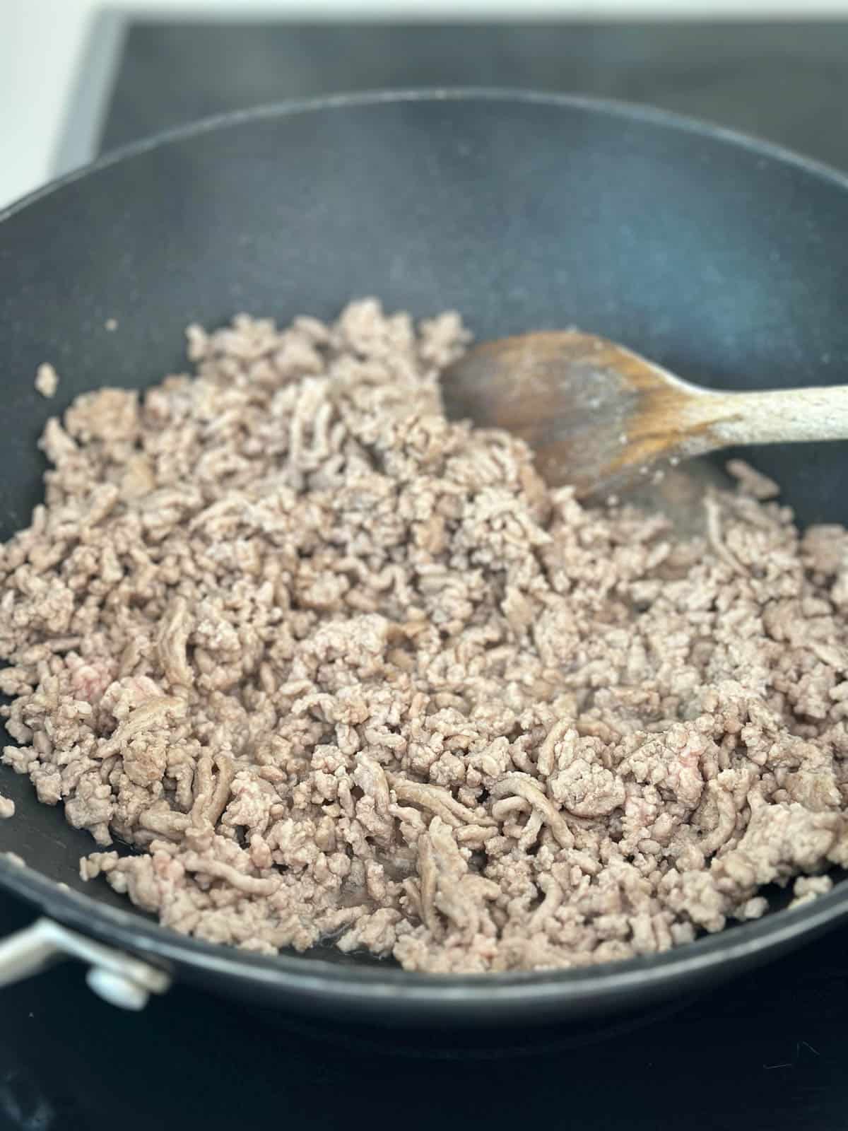 Pork mince browning in wok.