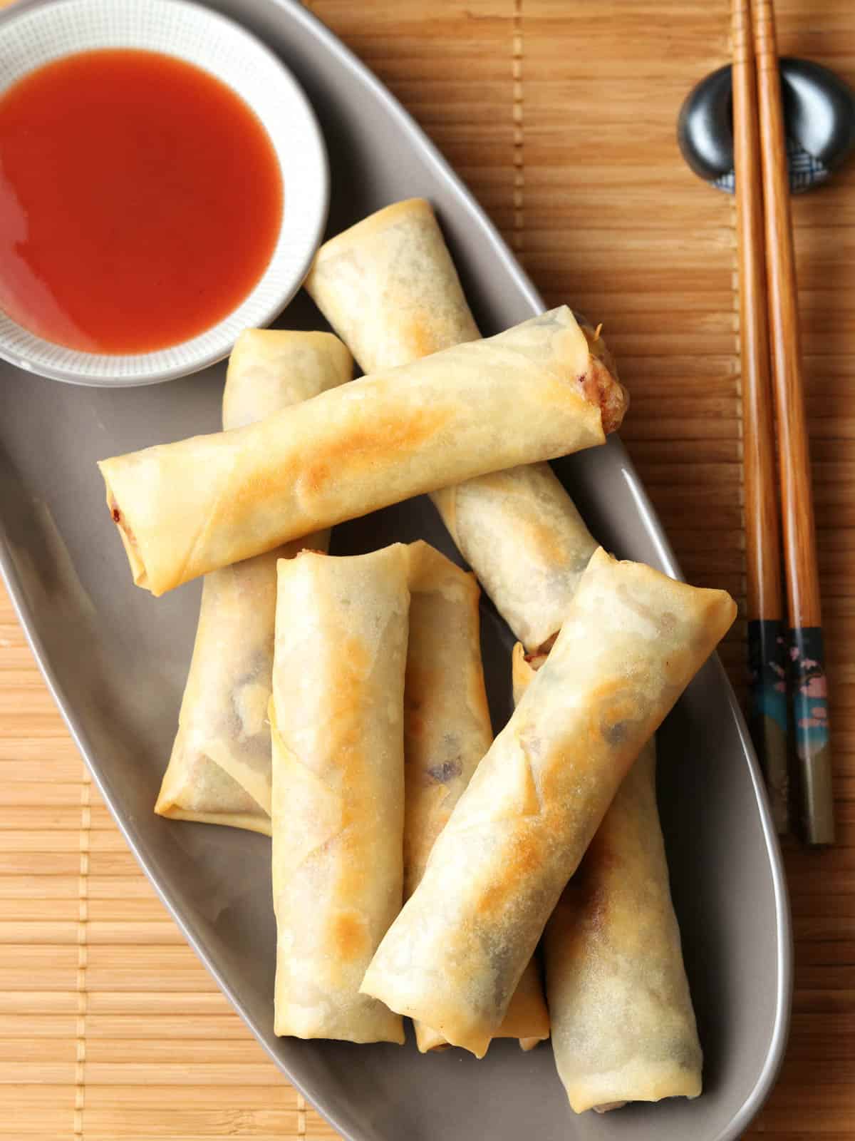 Spring rolls on a plate with sauce. 
