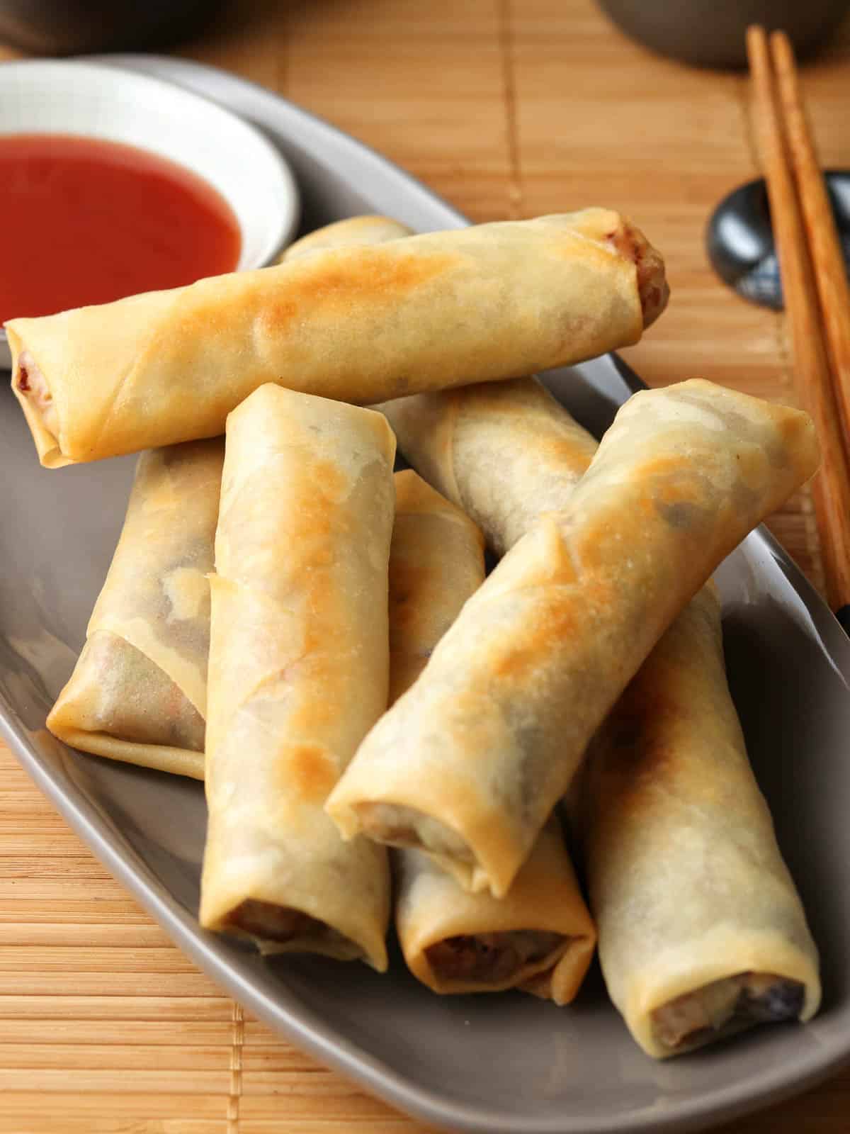 Spring rolls piled on a plate. 