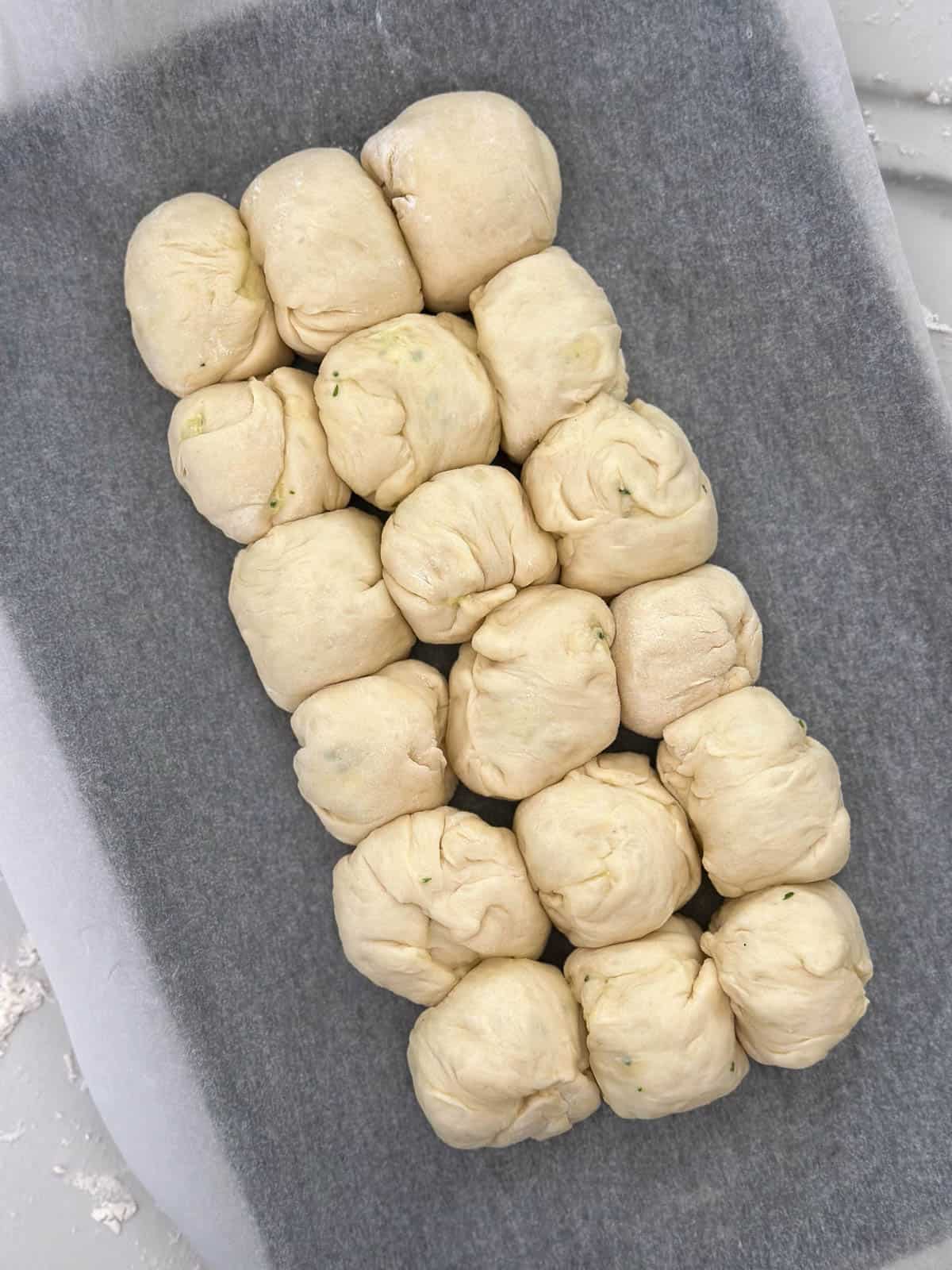 Thermomix bread dough shaped into balls and placed on a baking tray. 