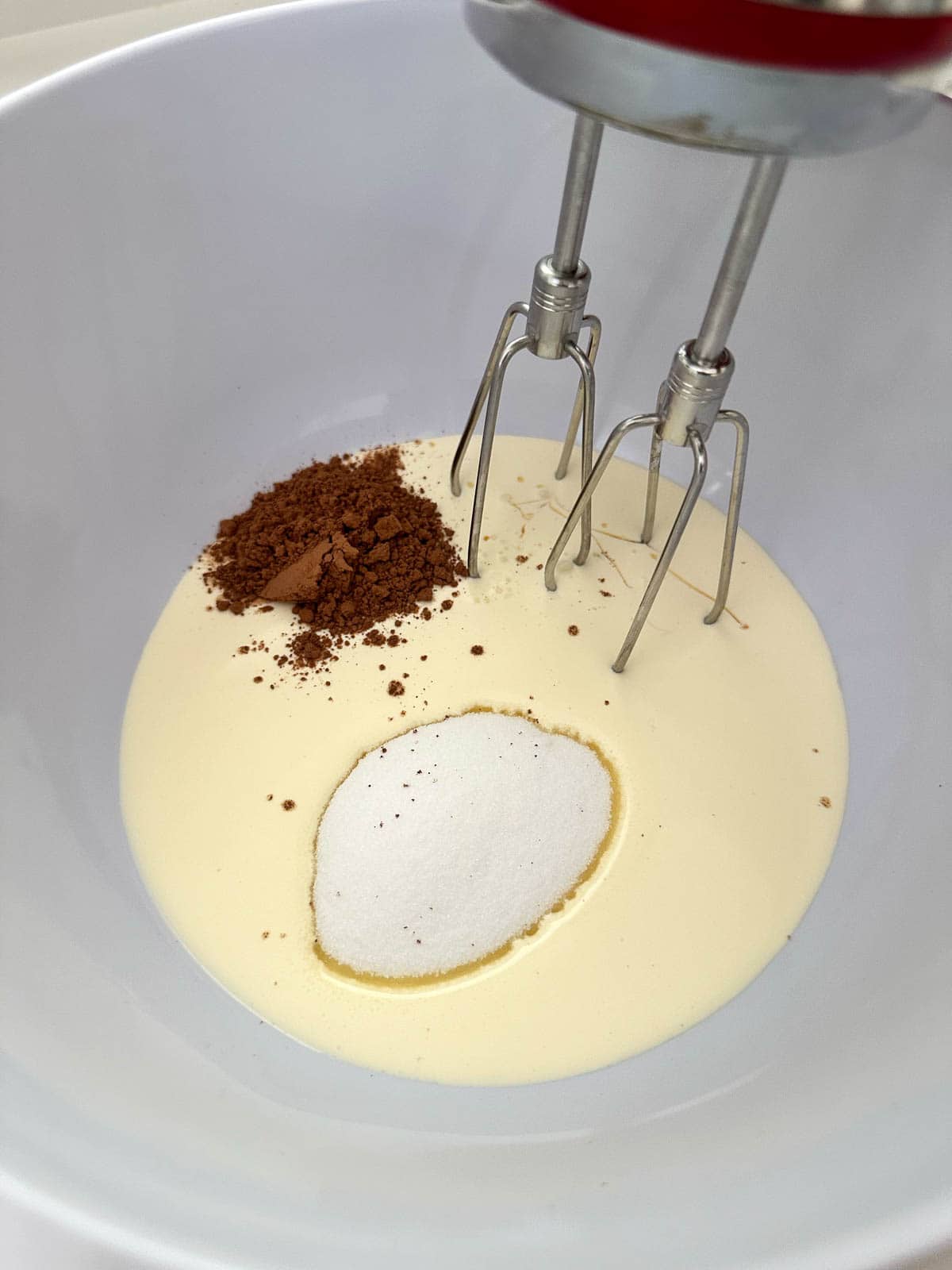 Ingredients for chocolate buttercream in a bowl.