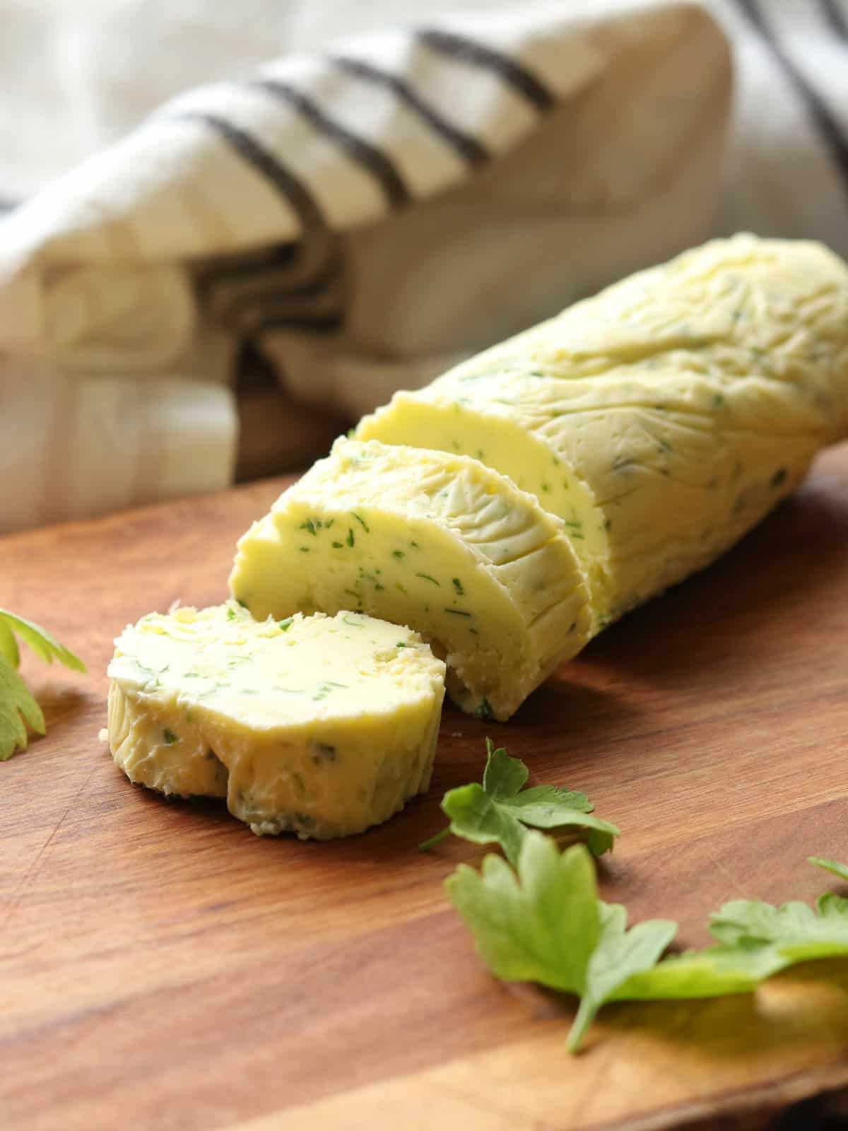 Sliced Thermomix garlic butter on chopping board.