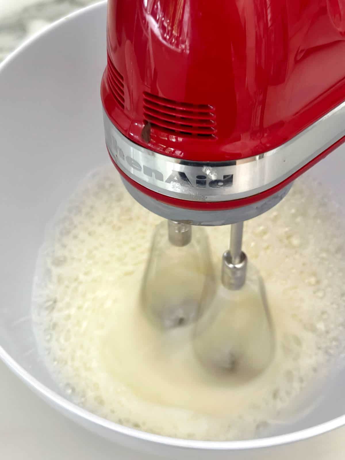 Whisking egg whites with an electric whisk. 