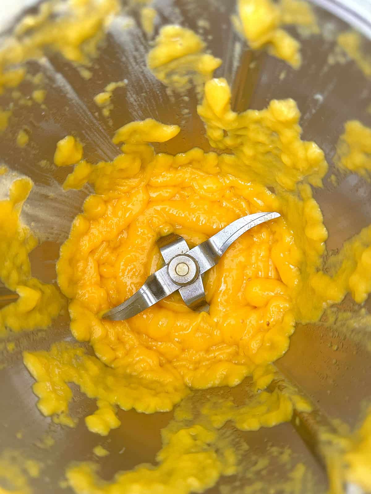 Mashed mango in Thermomix bowl.