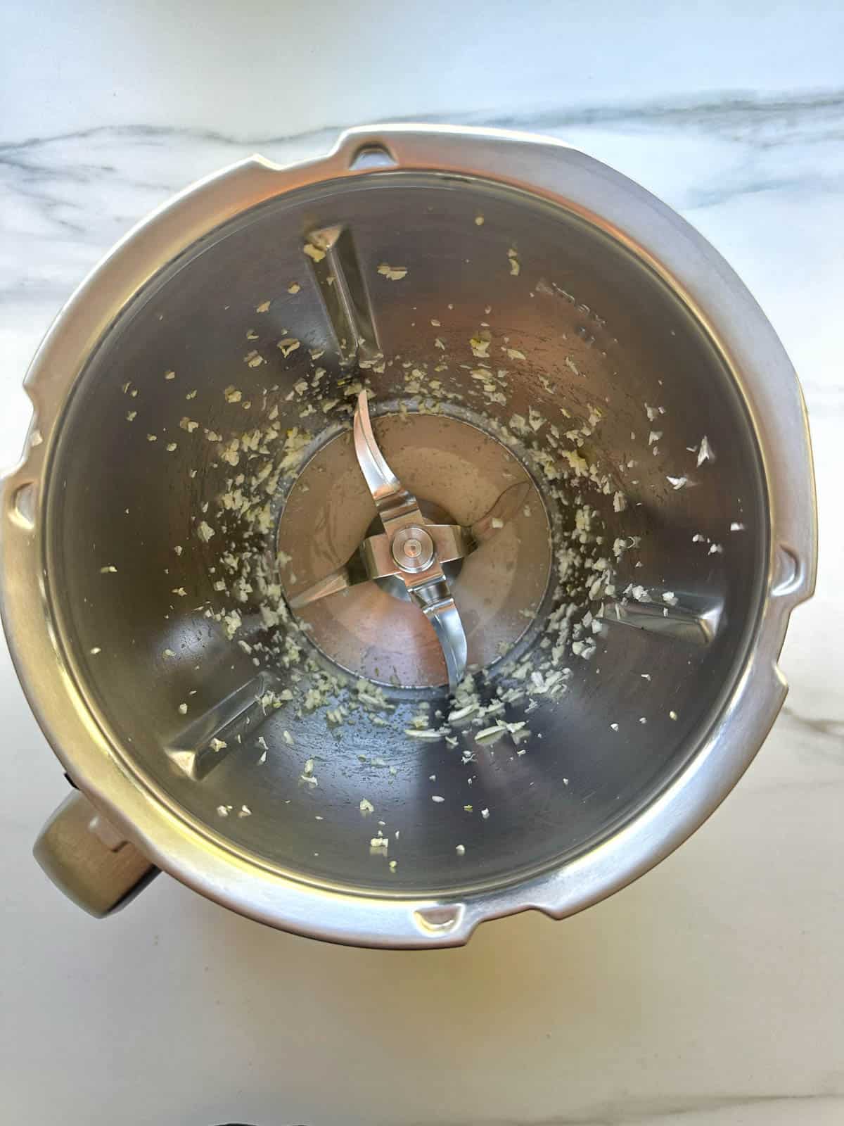 Chopped garlic in Thermomix bowl.