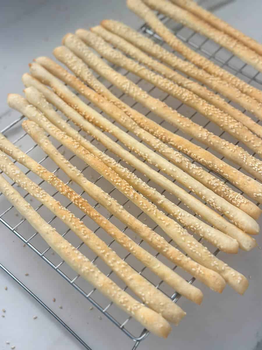 Homemade Thermomix Grissini cooling on a cooling rack. 