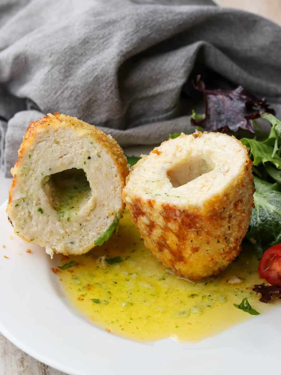 Thermomix Chicken Kiev on a plate with salad. 