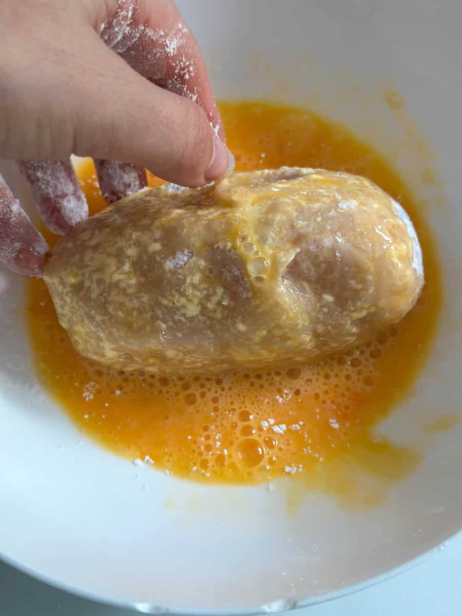 Chicken Kiev in an egg wash. 