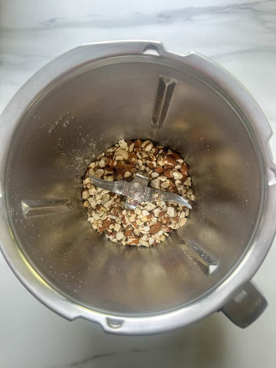 Chopped nuts in Thermomix bowl.