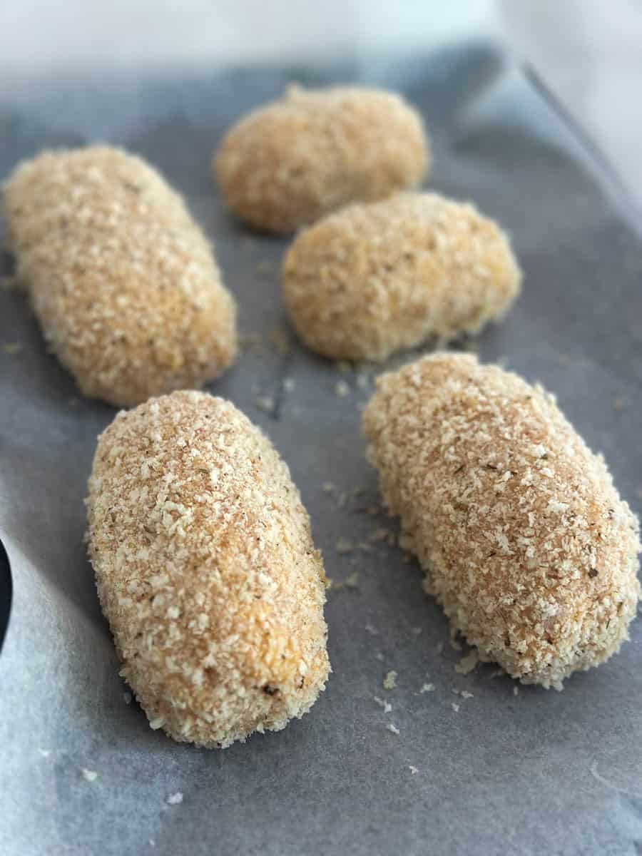 Crumbed Chicken Kievs on a tray. 