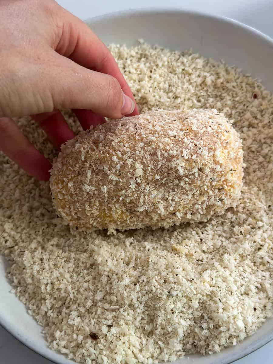 Rolling Chicken Kiev in crumb coating. 