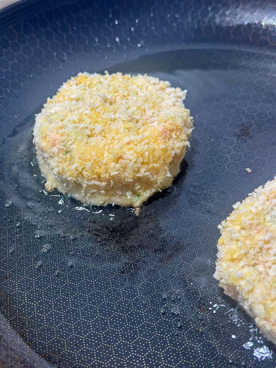 Shallow frying salmon fishcakes.