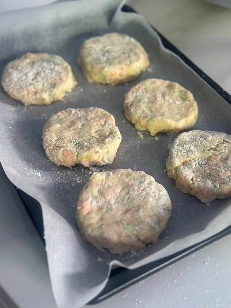 Salmon fishcake patties on a tray.