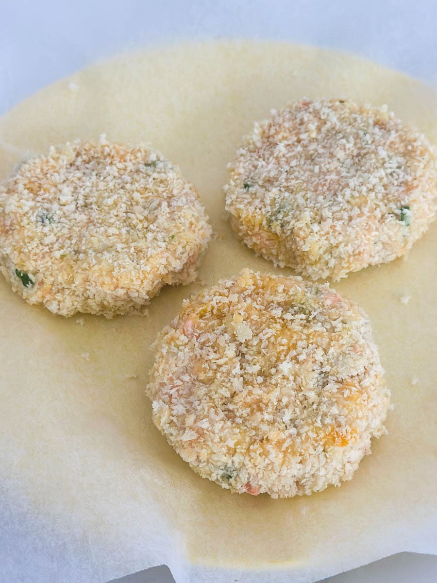 Crumbed fishcakes on a plate.