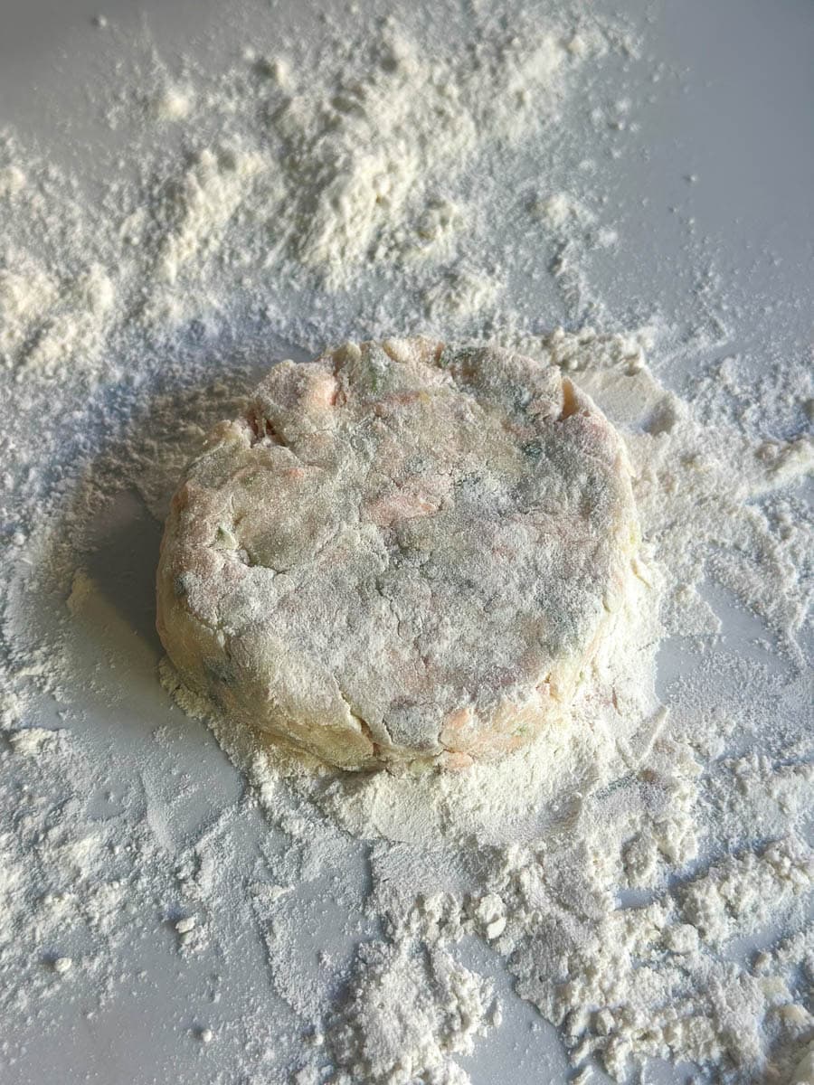 Salmon fishcake patty dredged wtih flour.