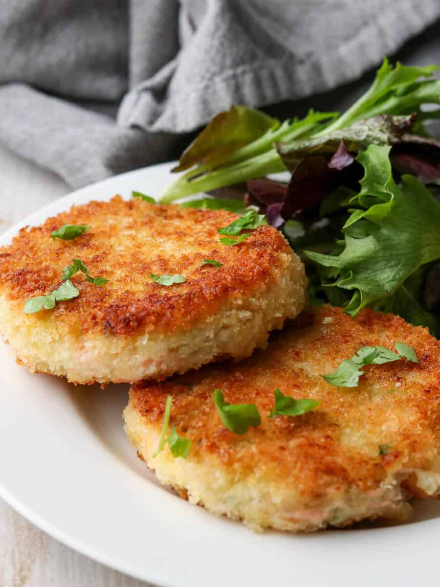 Thermomix Salmon Fishcakes served on a plate with salad.