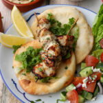 Air fryer chicken souvlaki served with flatbread and salad.