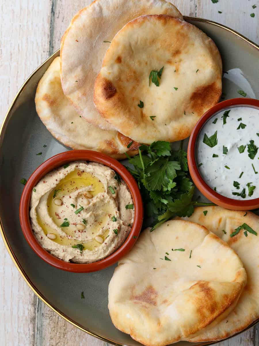 Air fryer flatbreads on a plate with dips.
