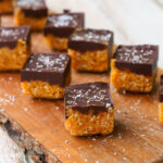 Chocolate Apricot energy bites on a wooden board.