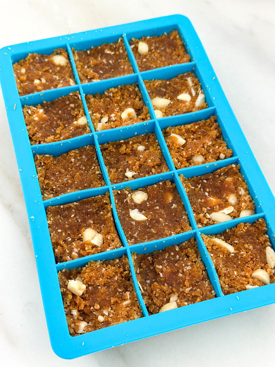 Thermomix Peanut Butter Chocolate Energy Bites mixture pressed into an ice tray.
